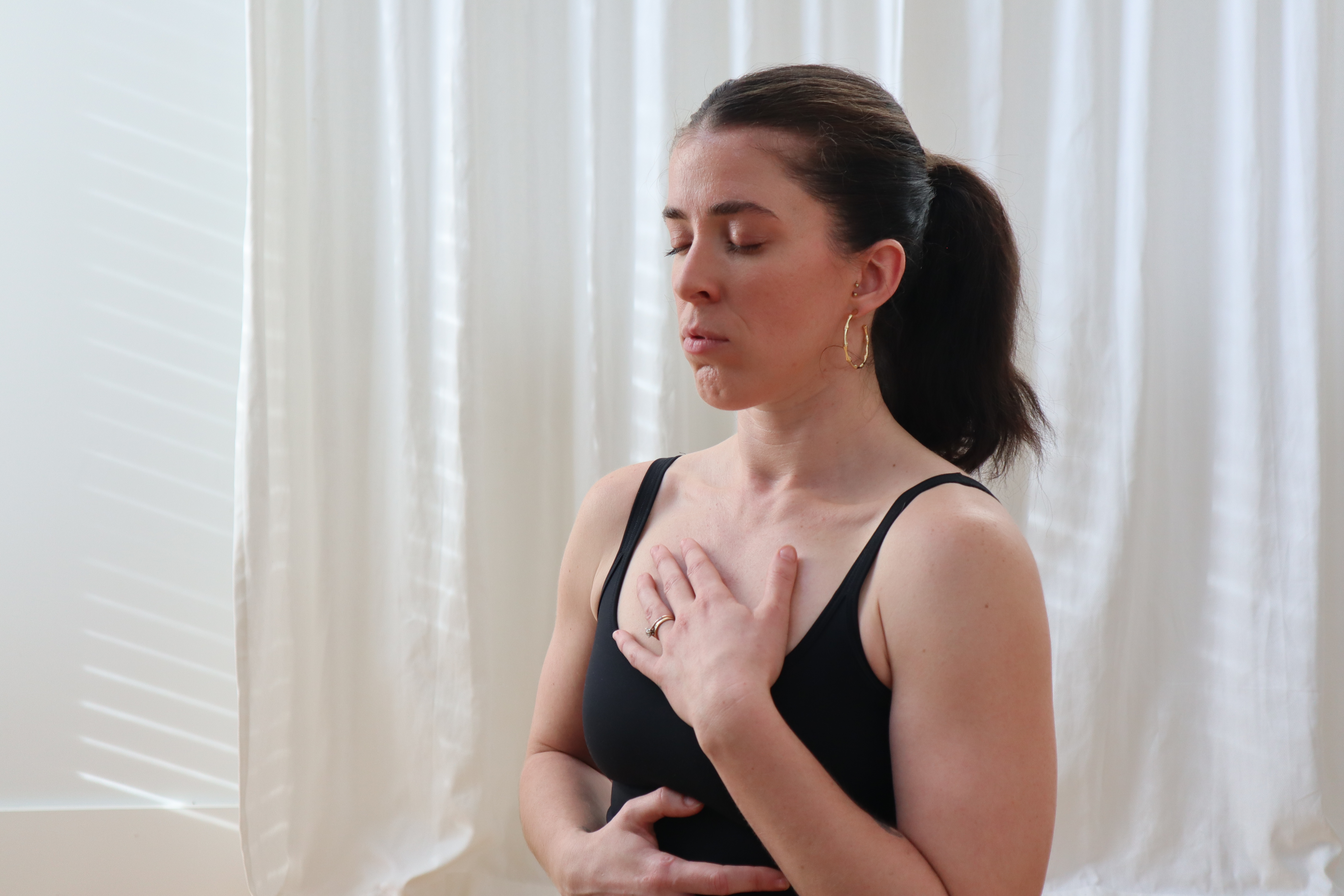 Victoria Scully leading a Pilates class in a professional studio setting